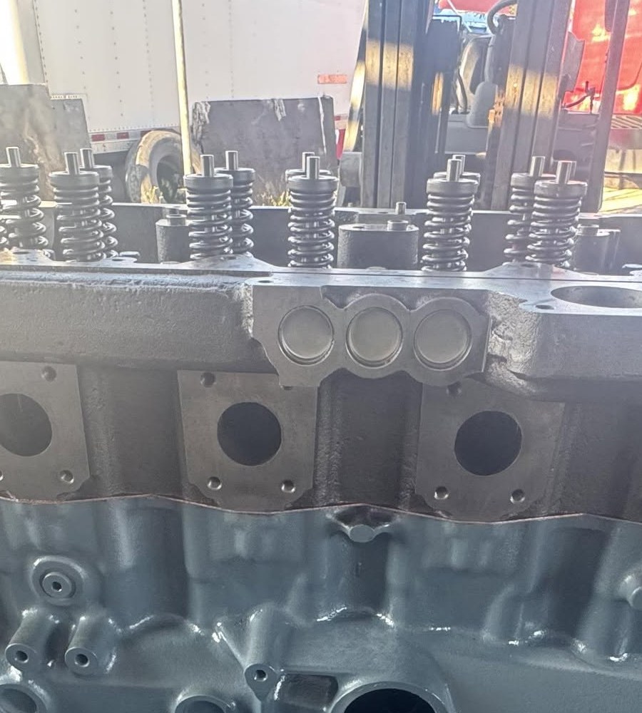 Close-up of the deck and head surface of a rebuilt diesel block